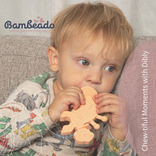 Load image into Gallery viewer, Dibly - Pink - Baltic Amber & Natural Rubber Dinosaur Teether with Toothbrush Tail